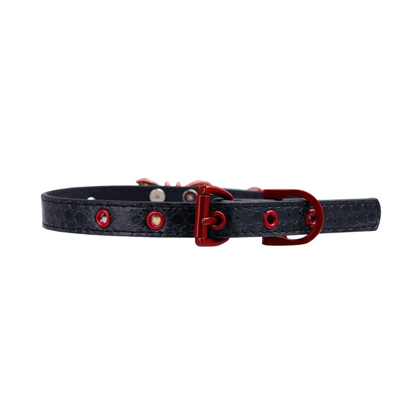 Close-up detail of red buckle hardware and adjustable leather construction