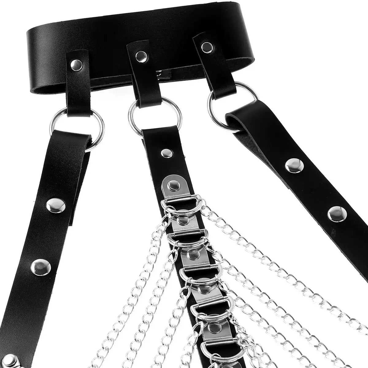 Close-up detail of faux leather straps and metal chain hardware on harness