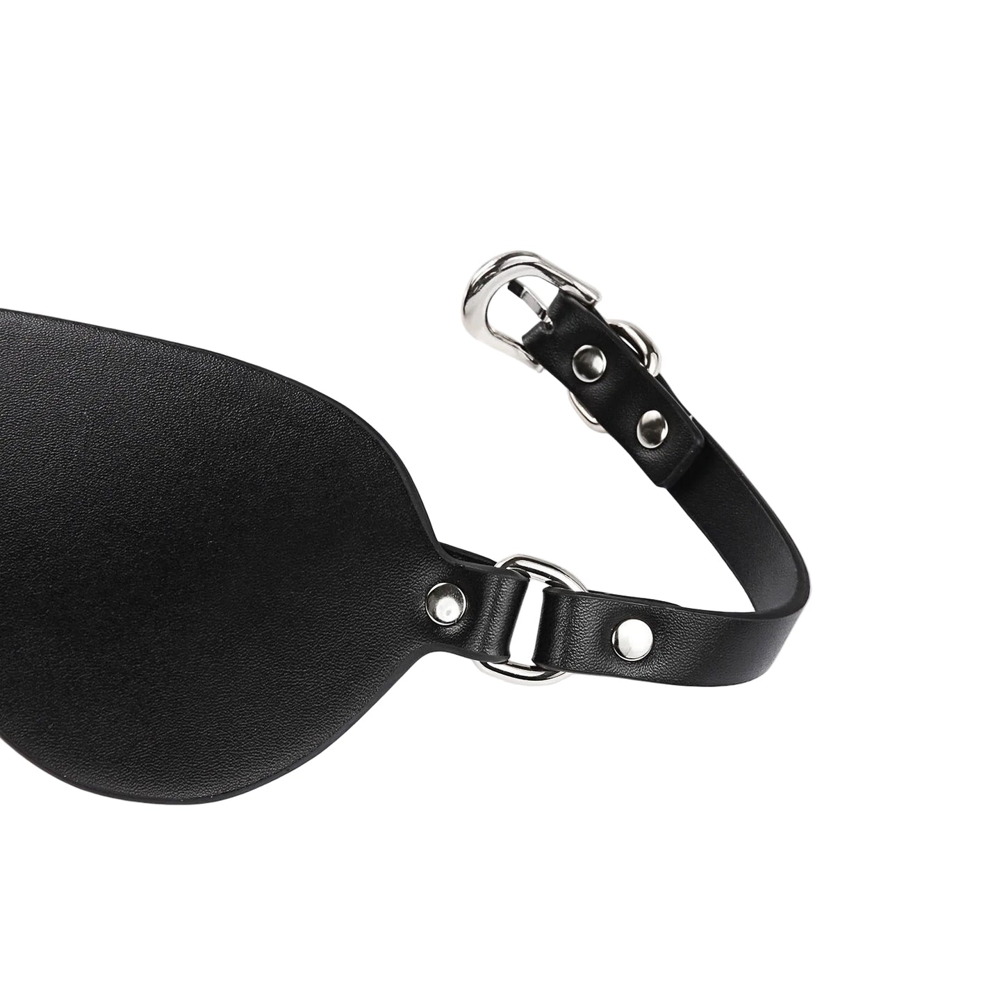 Close-up detail of faux leather material and metal hardware on eye mask