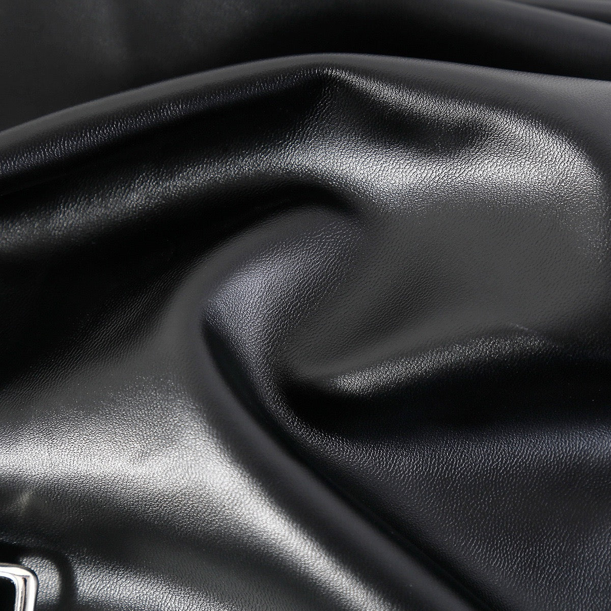 Close-up detail of faux leather material used on performance jacket