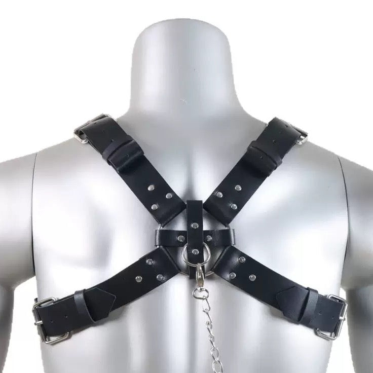 Back view of black faux leather spike detail harness suspender with adjustable straps and chain accessory