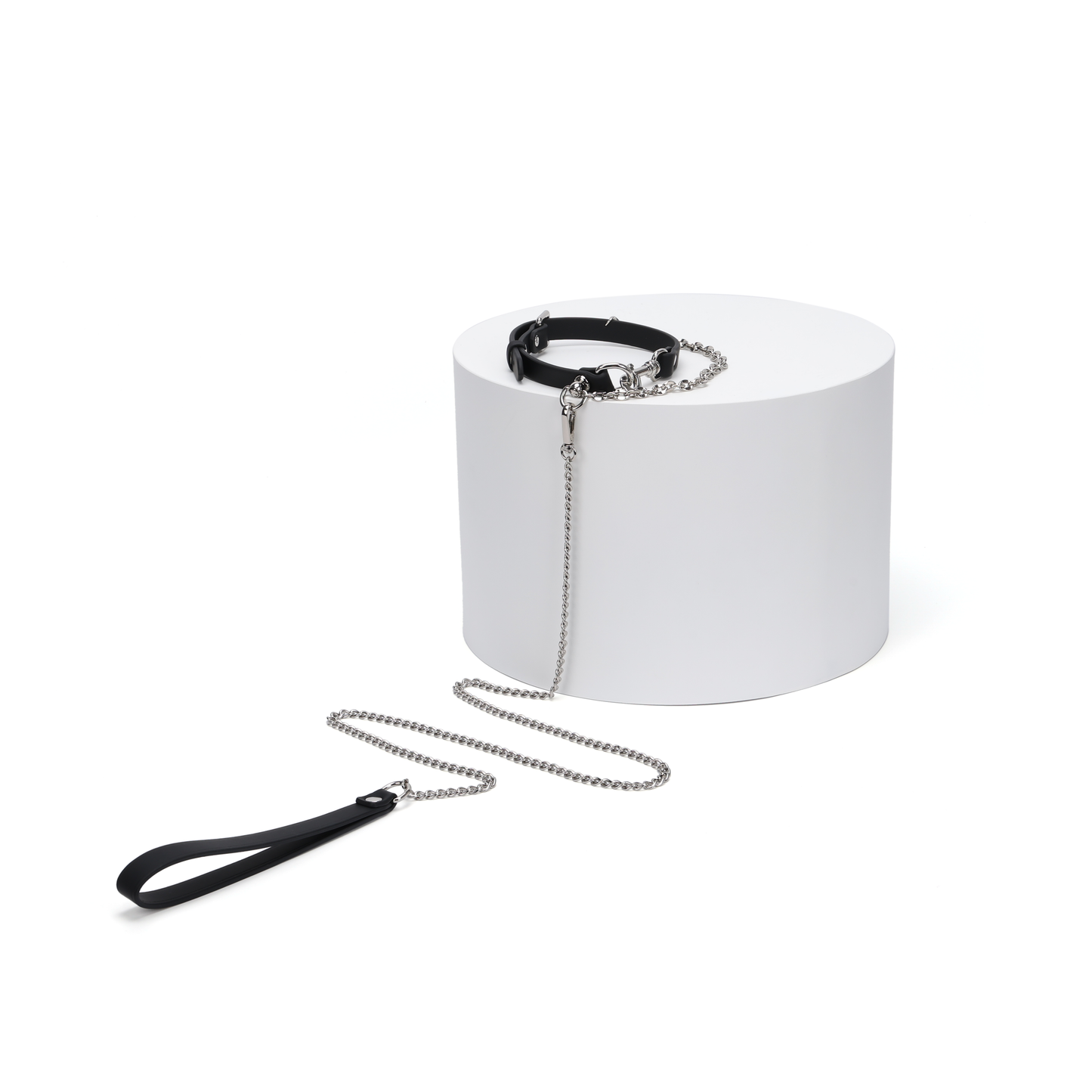 Stainless steel chain choker and matching chain accessory displayed on white block