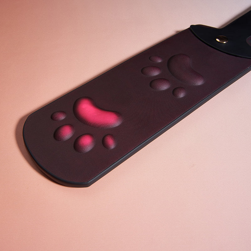 Heat reactive faux leather paddle featuring embossed paw pattern