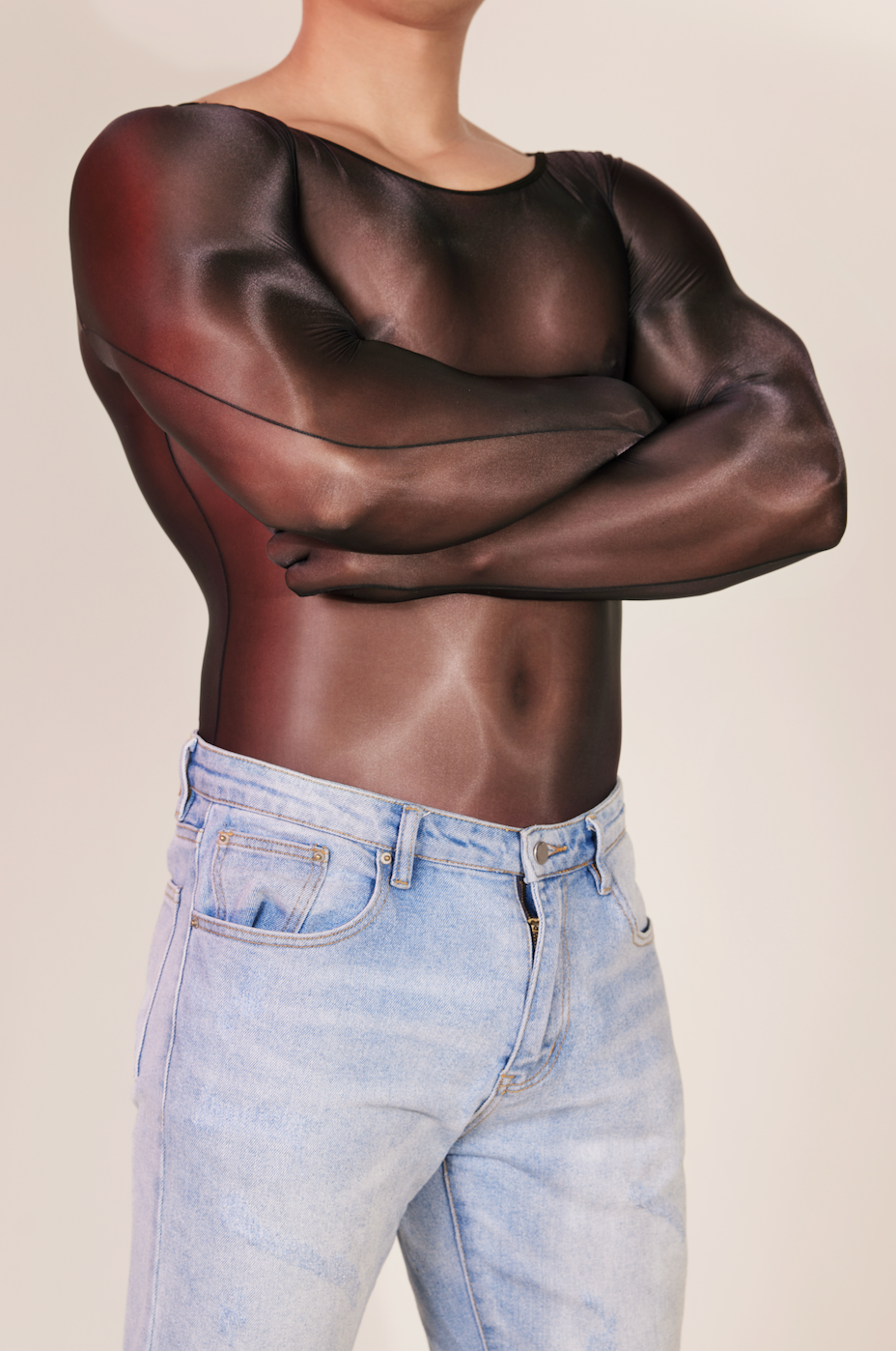 Side profile of men’s sheer gloved bodysuit styled with denim