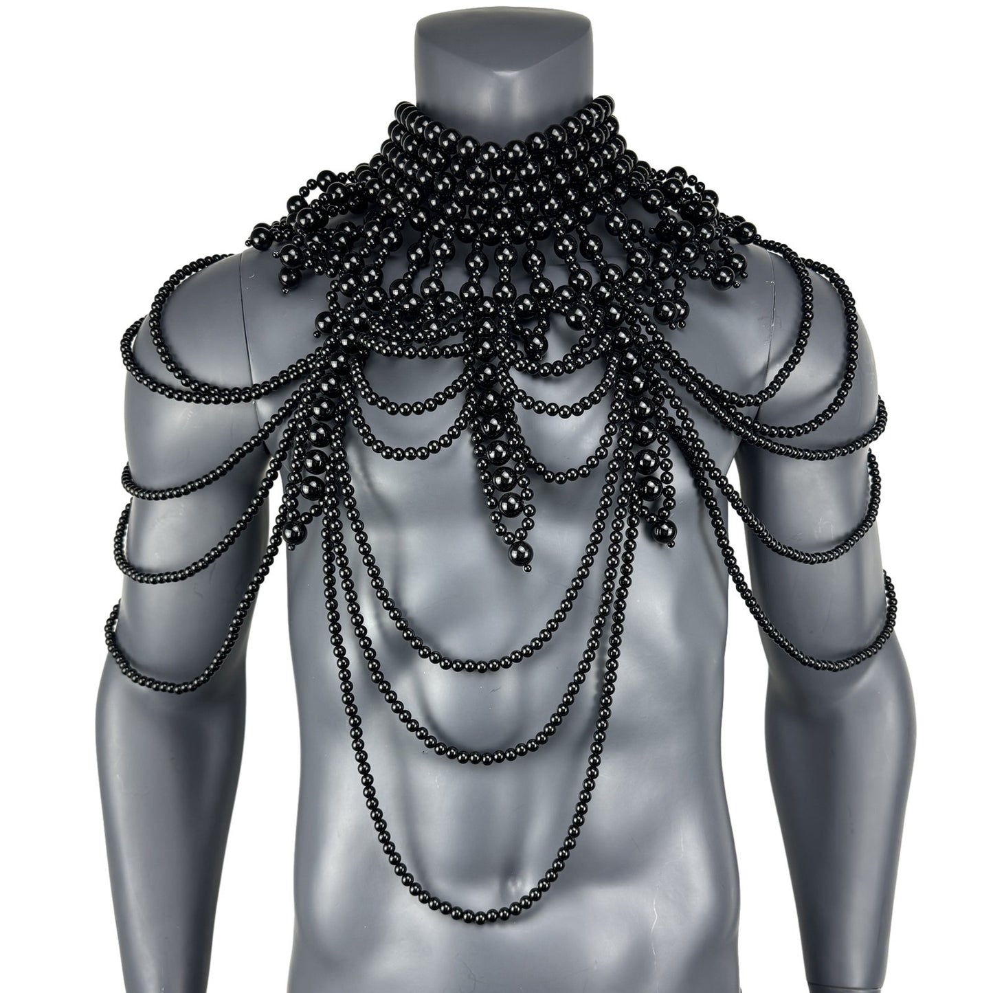 Black faux pearl cape top displayed on mannequin