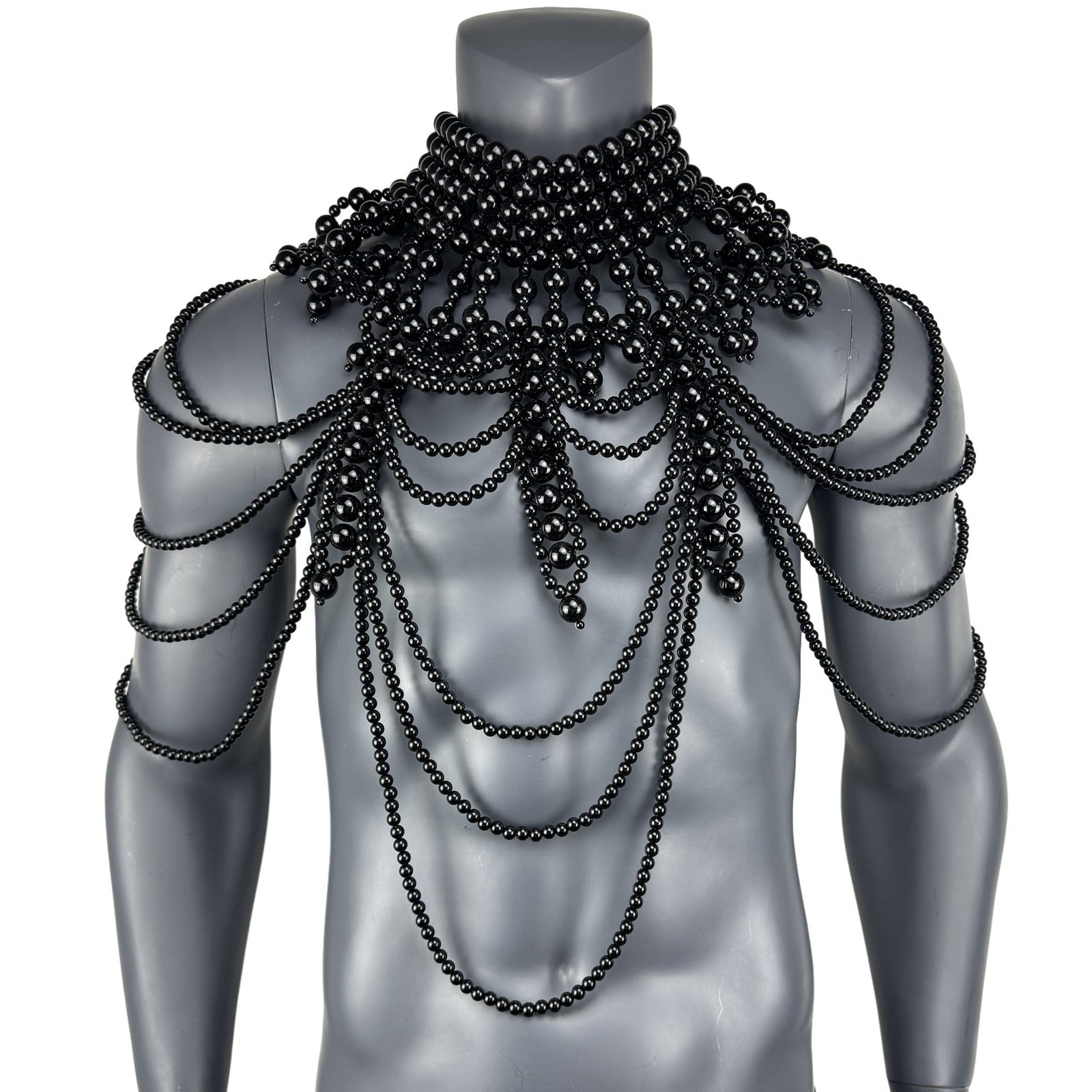 Black faux pearl cape top displayed on mannequin
