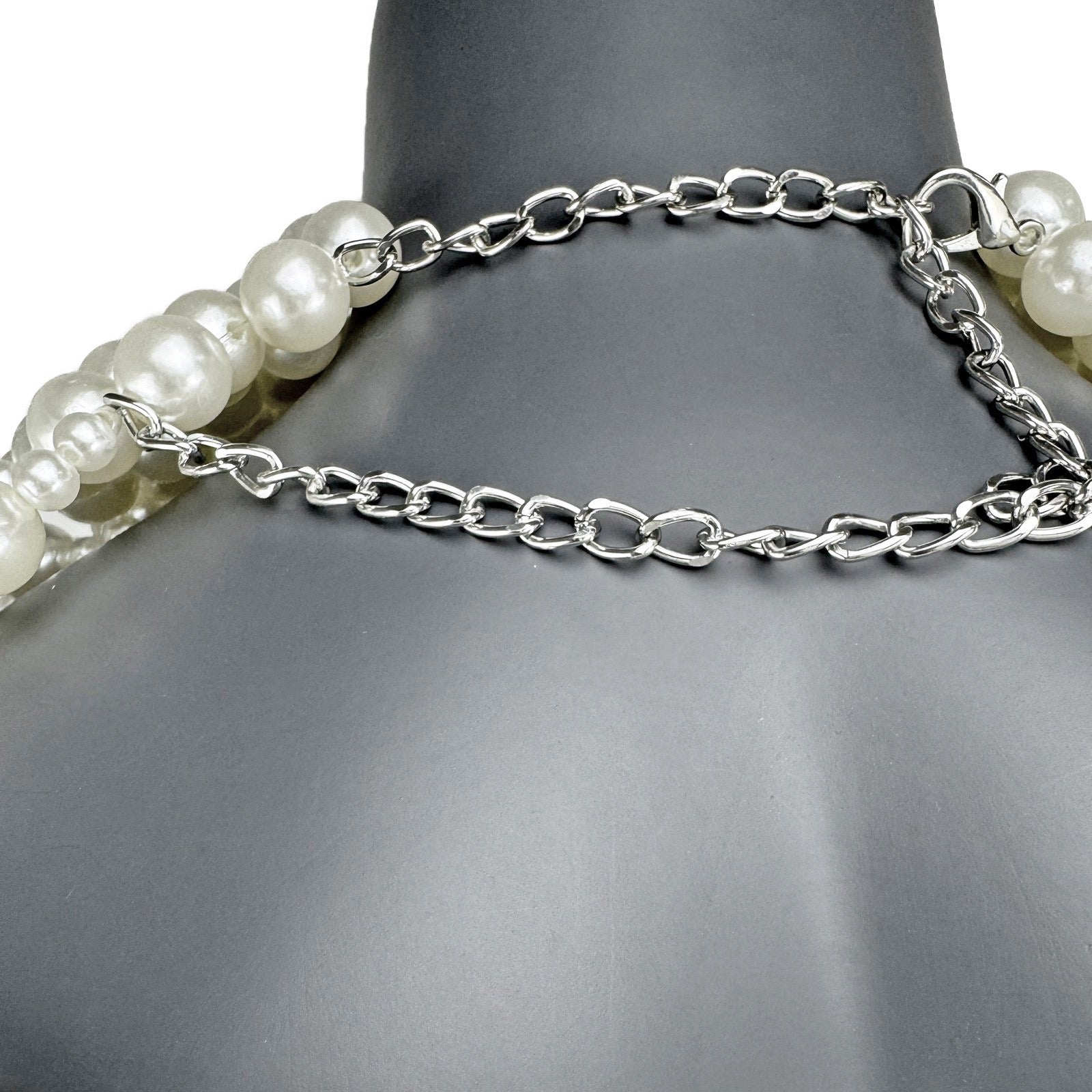 Close-up detail of layered white pearl strands on cape top back