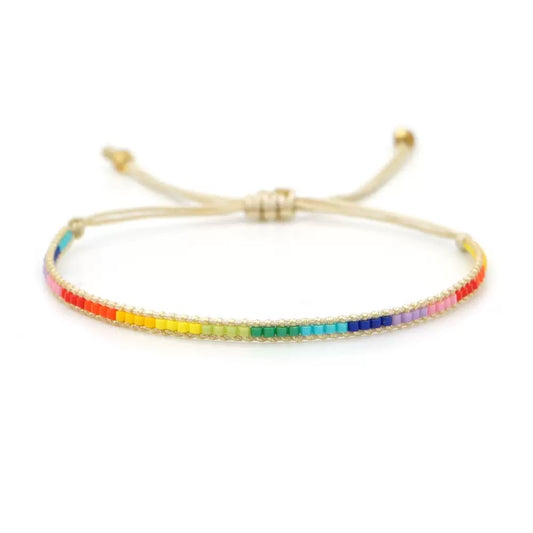 Handmade pride bracelet with colorful woven bead details