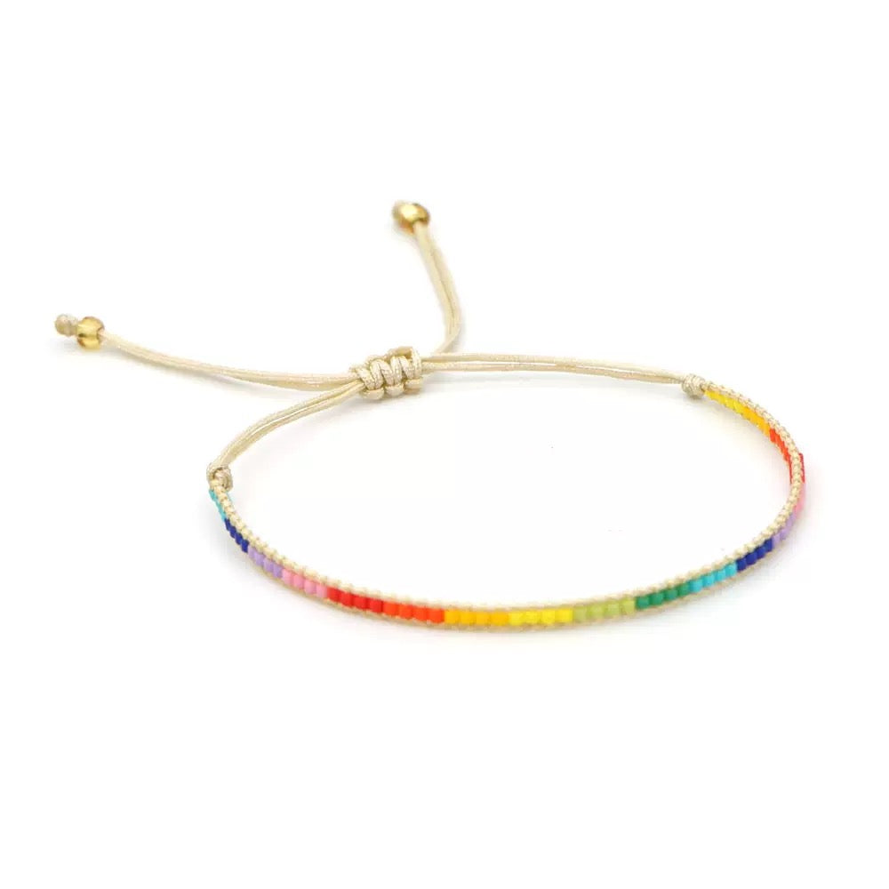 Side view of handmade pride bracelet with adjustable tie closure