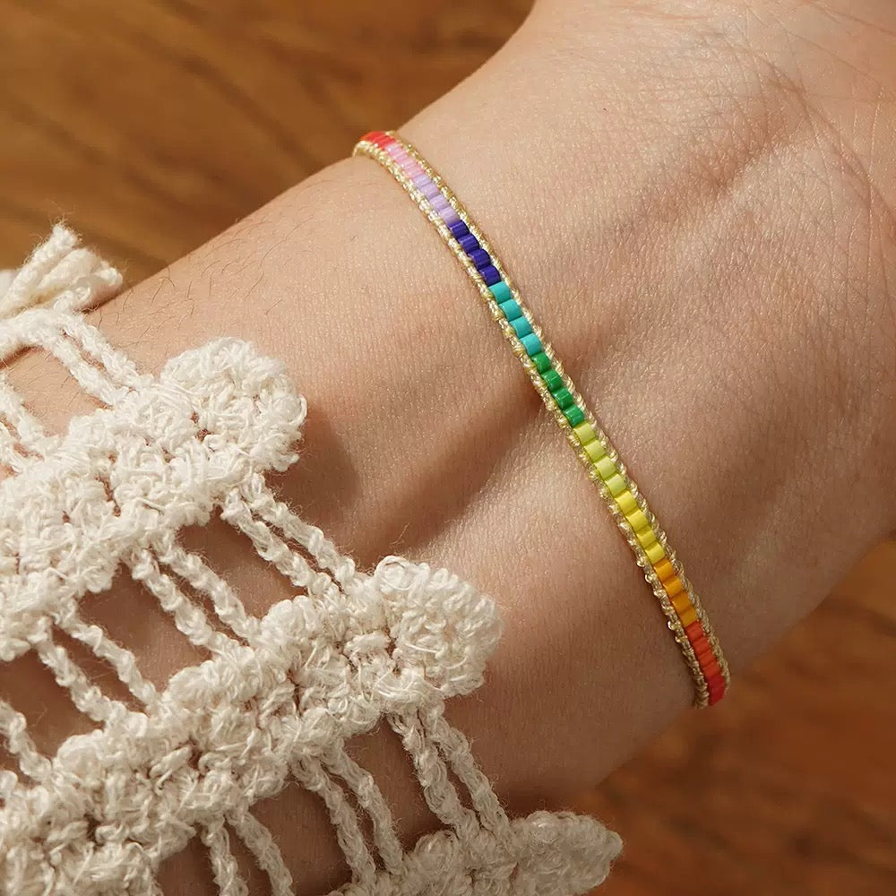 Handmade pride bracelet shown worn on wrist